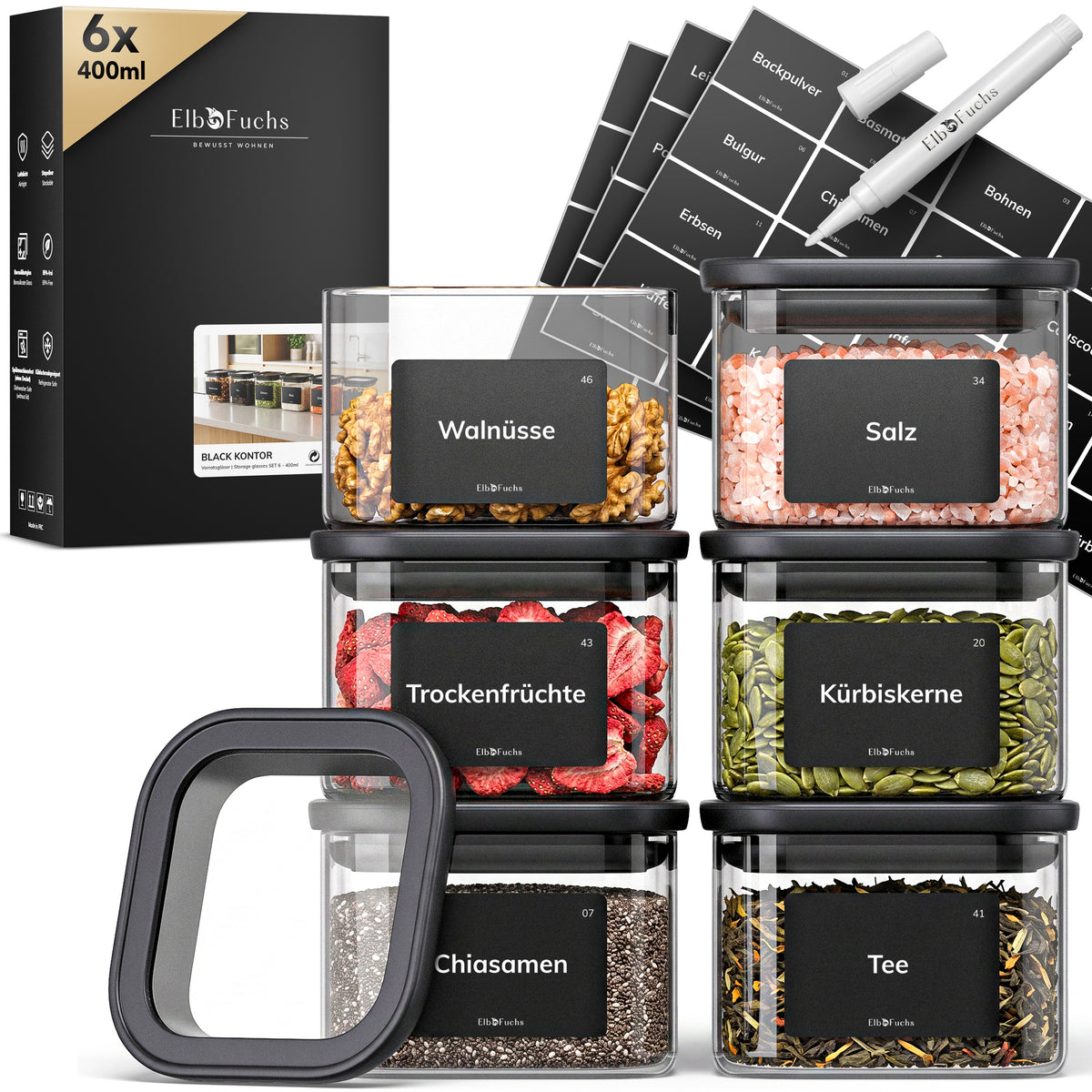 Sechs ElbFuchs BLACK KONTOR Vorratsgläser à 400 ml mit schwarzem Deckel, gefüllt mit Walnüssen, Salz, Trockenfrüchten, Kürbiskernen, Chiasamen und Tee, inklusive Etiketten und Kreidestift.