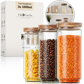 ElbFuchs Vorratsgläser 1000ml im 3er-Set der Serie WOOD KONTOR, gefüllt mit gelben Fusilli, Kaffeebohnen und roten Linsen, davor die zugehörige Verpackung mit Produktdetails.