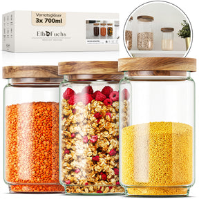 ElbFuchs Vorratsgläser 700ml im 3er-Set WOOD KONTOR, gefüllt mit roten Linsen, Müsli mit Himbeeren und Haferflocken sowie gelber Hirse, davor die passende Verpackung mit Produktdetails.